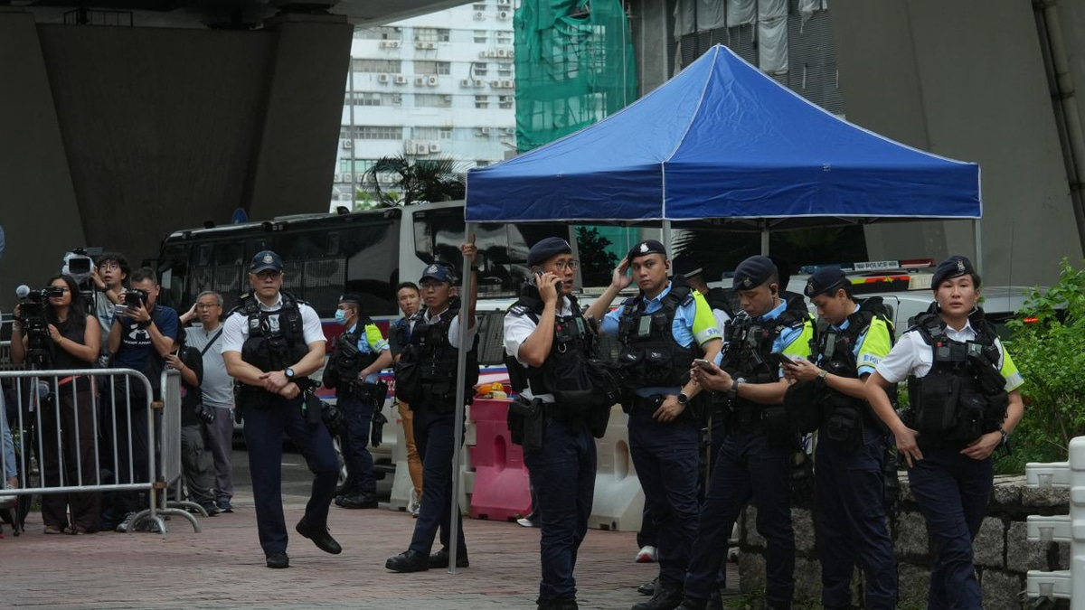 Hong Kong police arrest woman for seditious T-shirt outside court as democracy activists convicted